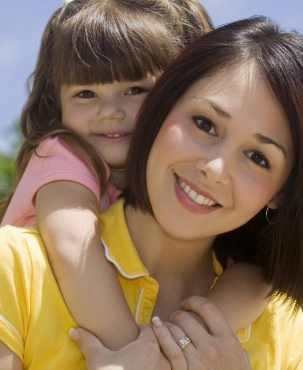 A woman holding her daughter on her back